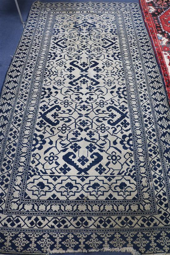 An Indian ivory & blue ground rug , 300cm x 152cm